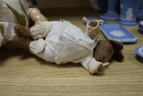 An early 20th century Bisque jointed doll with open mouth and sleeping eyes, and two small plush animals